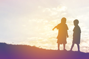 silhouette of a happy children and happy time sunset