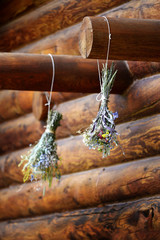 Floral Boquet of flowers drying on beam of log cabin