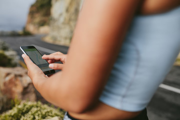 Female runner using mobile phone app