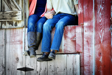 Fototapeta na wymiar Couple Next to Old Barn Holding Hands