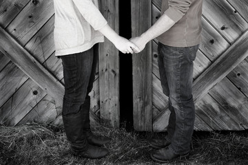 Couple Next to Old Barn Holding Hands