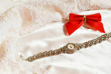 Silver hand watch on the white lace