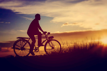 silhouette of bicycle with man