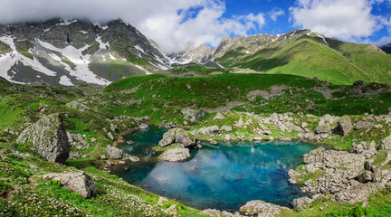 Fototapeta na wymiar Picturesque lake in valley of Caucasus mountains