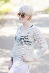 Young woman in sunglasses and a net top