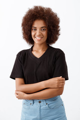 Beautiful african girl smiling over light background.