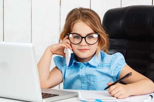Young beautiful girl speaking phone at working place in office.