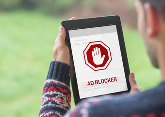 Ad blocker on the screen of a young man tablet