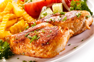 Fried chicken fillet, chips and vegetable salad 