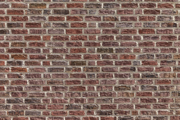 Naklejka premium Typical wall with red bricks.