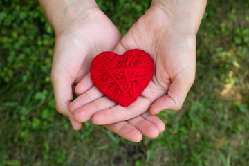 red woolen heart in a human hand, valentines day, love