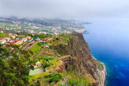 Cabo Girao, Madeira. View from the second highest sea cliff in the world towards Funchal on a foggy day