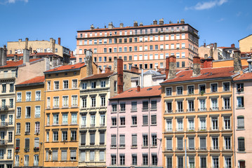 Fototapeta na wymiar Typical facades of the houses in Lyon, France on the banks of the Saone river 