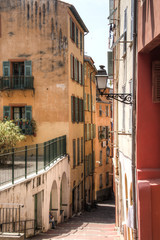 Fototapeta na wymiar Facades of houses in a small street in Nice on the French Riviera 
