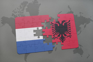puzzle with the national flag of netherlands and albania on a world map background.