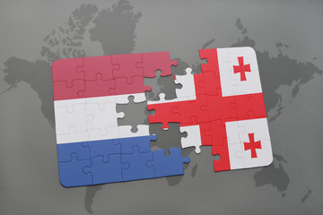 puzzle with the national flag of netherlands and georgia on a world map background.