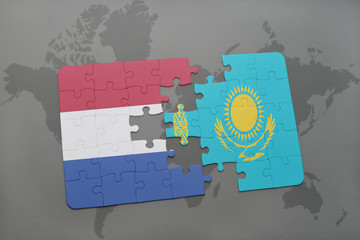 puzzle with the national flag of netherlands and kazakhstan on a world map background.