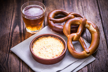 Hot cheese fondue with pretzel