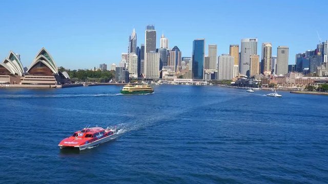 Aerial footage of Red Rocket Ferry at Sydney Opera House in Sydney Harbour, featuring Sydney CBD, Sydney Sky Line, City, Sydney Opera House, Sydney Ferries (ferry), Circular Quay,  Parramatta River. 