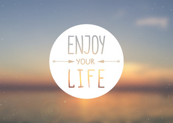 Enjoy your life - quote poster with lettering on the blurred background.