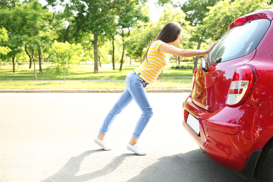 Woman Pushing Red Car