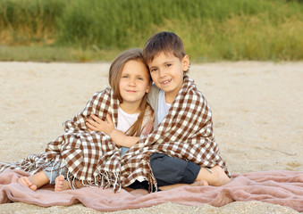 Two cute kids relaxing on beach