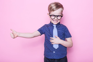 Portrait of a little smiling boy in a funny glasses and tie. School. Preschool. Fashion. Studio...