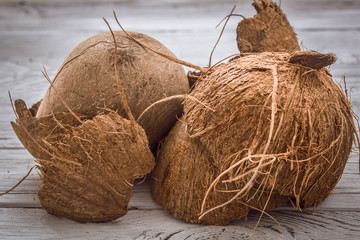 coconut whole nuts scattered shavings of  on wooden background