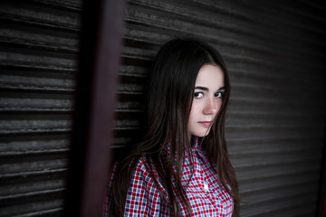 Young girl in a checkered shirt outdoor