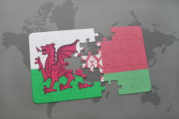 puzzle with the national flag of wales and belarus on a world map background.