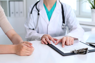 Doctor and patient are discussing something, just hands at the table