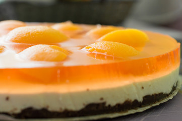 Homemade cheesecake with apricot slices on the table