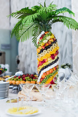Palm tree decorated with exotic fruits on the wedding