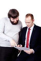 Two business people in elegant suits sitting at desk working in team together with documents sign up contract, holding clipboard, folder with papers, business plan. Isolated over white background.