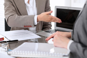 Group of business people or lawyers at meeting  discussing contract papers. Woman pointing into...