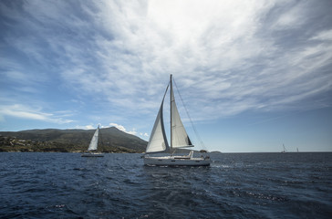 Beautiful yacht sailing on the sea near the island.