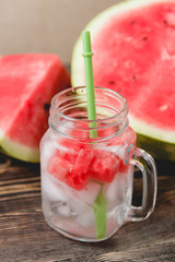 Watermelon Drink in Glass with Slices on Wooden Background