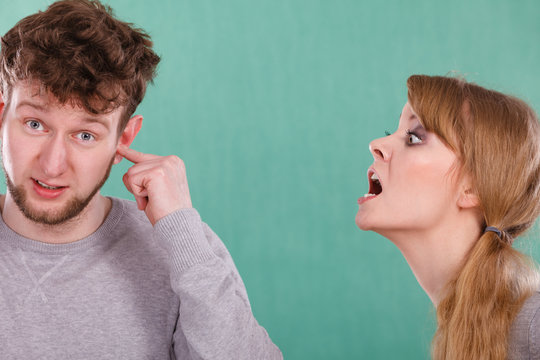 Aggressive woman yelling on man.