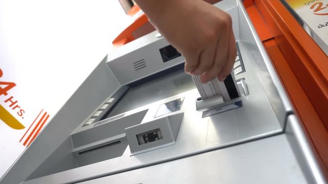 Woman withdraw cash from ATM