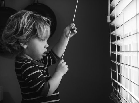 Young Child Looking Out Window