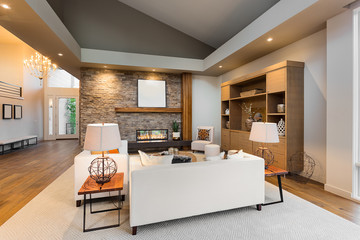Beautiful living room interior with hardwood floors and fireplace in new luxury home
