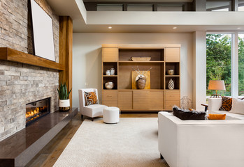 Beautiful living room interior with hardwood floors and fireplace in new luxury home