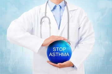 Doctor holding blue crystal ball with stop asthma sign on medical background.