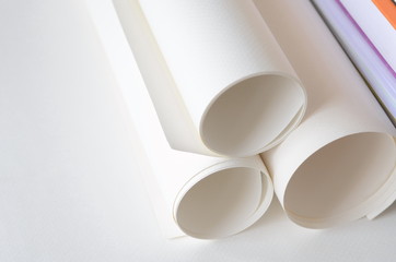 Roll of white papers with copy space for text on left side.
