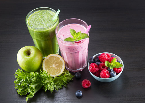 Glasses of fresh cold smoothie with fresh fruit and spinach and fresh beries