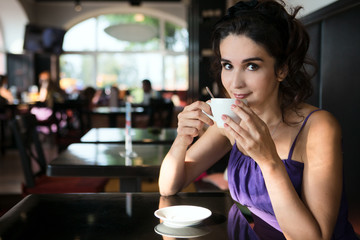 Attractive woman drinking coffee in a cafe