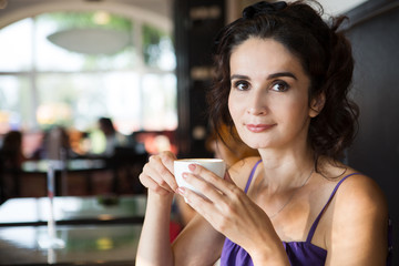 Attractive woman drinking coffee in a cafe