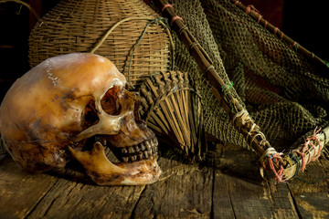 still life with skull and net on wooden