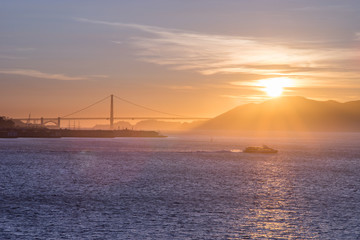 Fototapeta na wymiar Tourist cruise sails in San Francisco Bay at Sunset