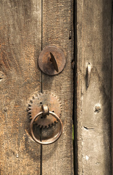 Rusty iron fittings hardware of old weathered wooden board of door 
